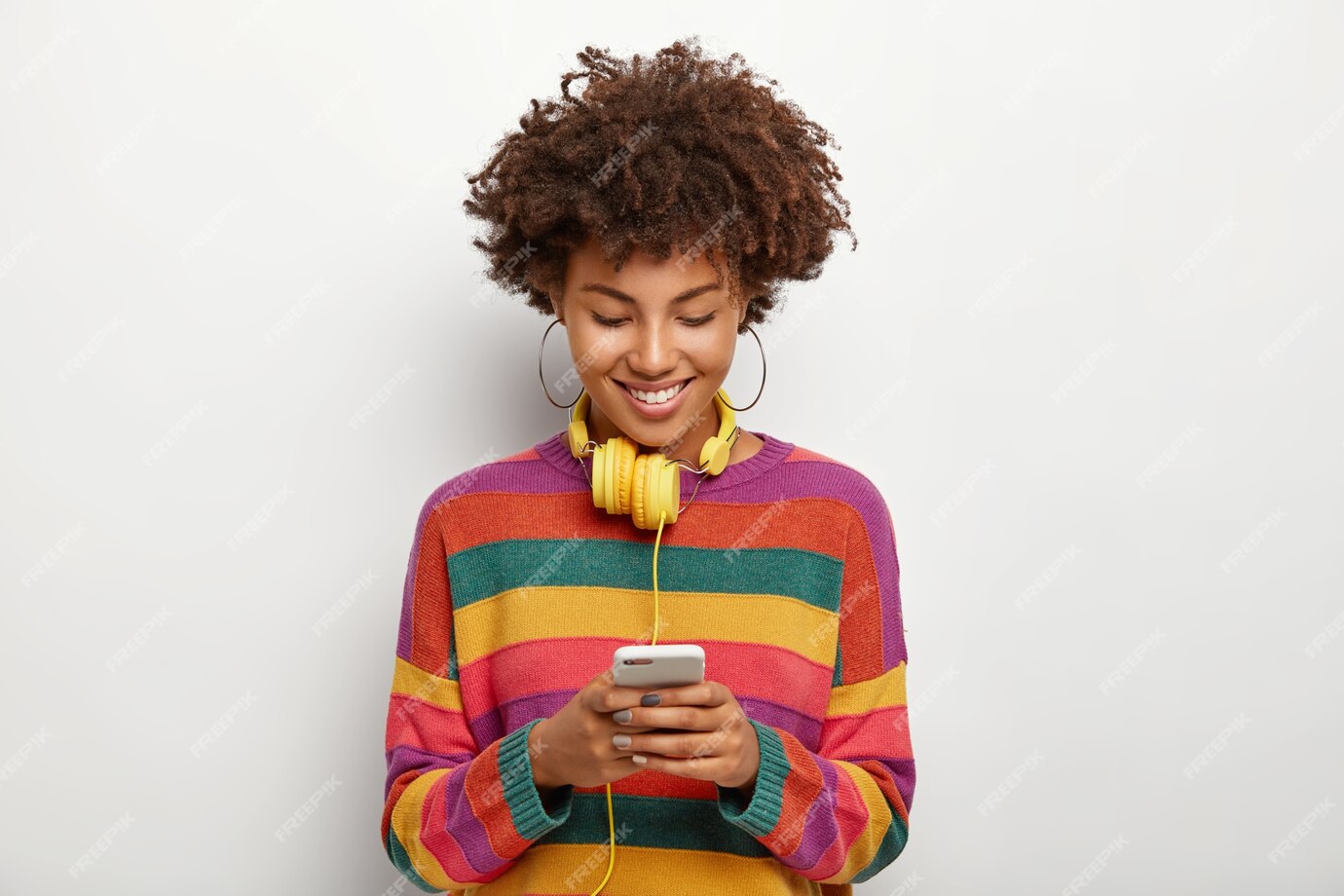 Photo of beautiful Afro American woman concentrated on a smartphone device