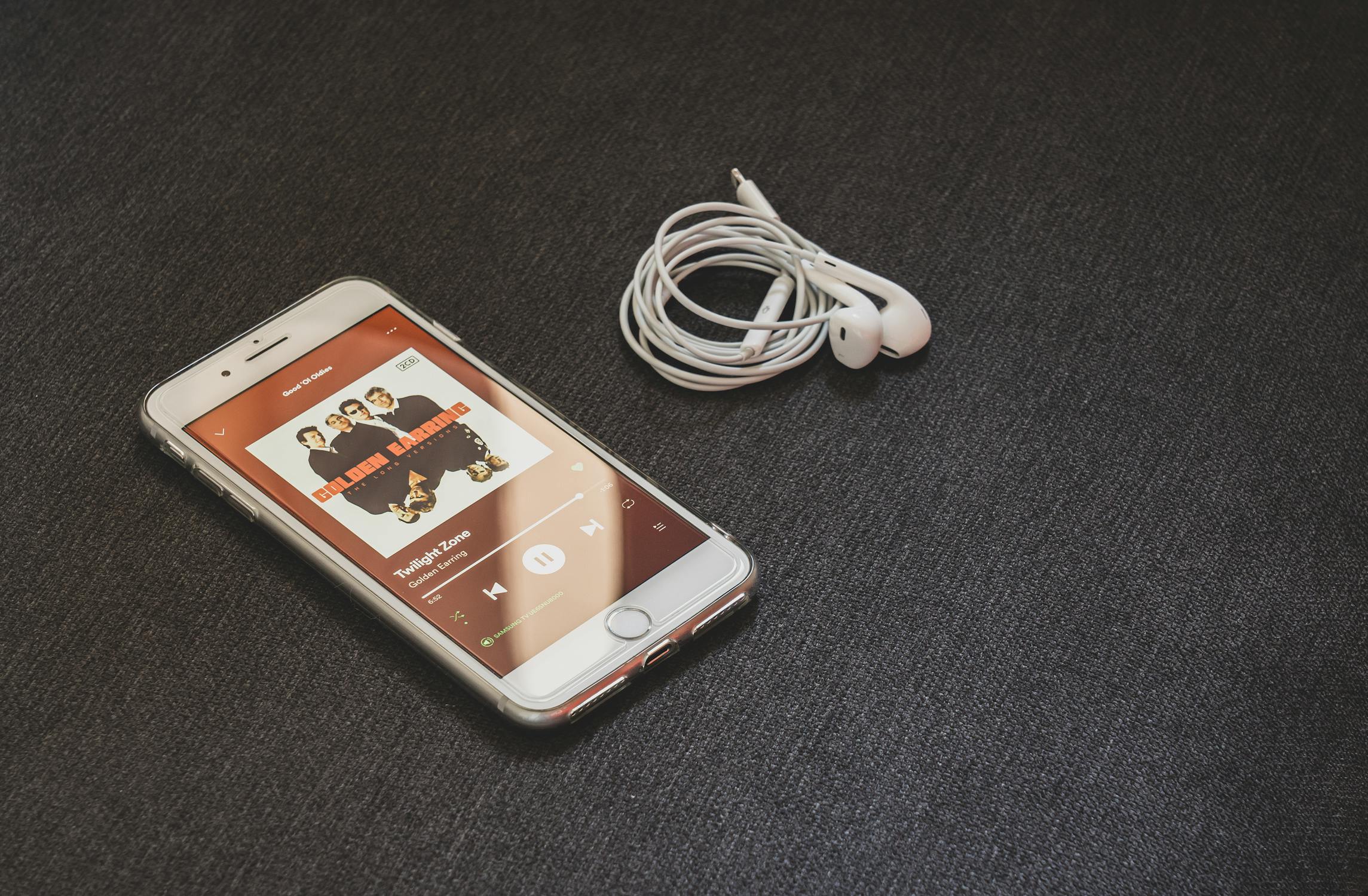 Silver Iphone 6 With Earphones On Gray Surface